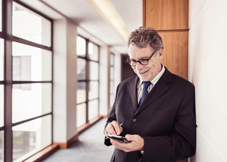 sample_0003_senior-businessman-in-office-corridor-using-smartp-2022-03-07-23-56-07-utc.jpg